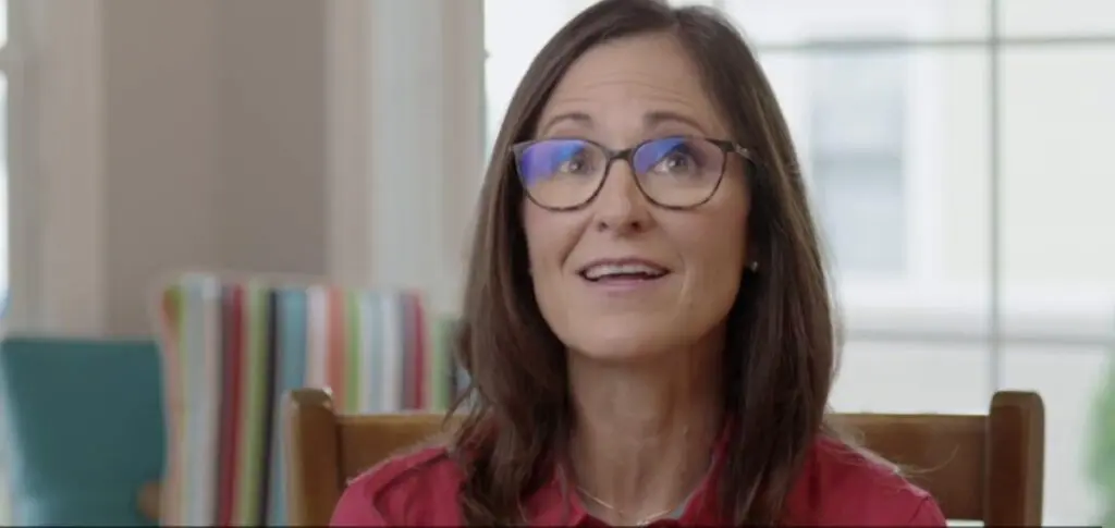 woman wearing glasses and smiling